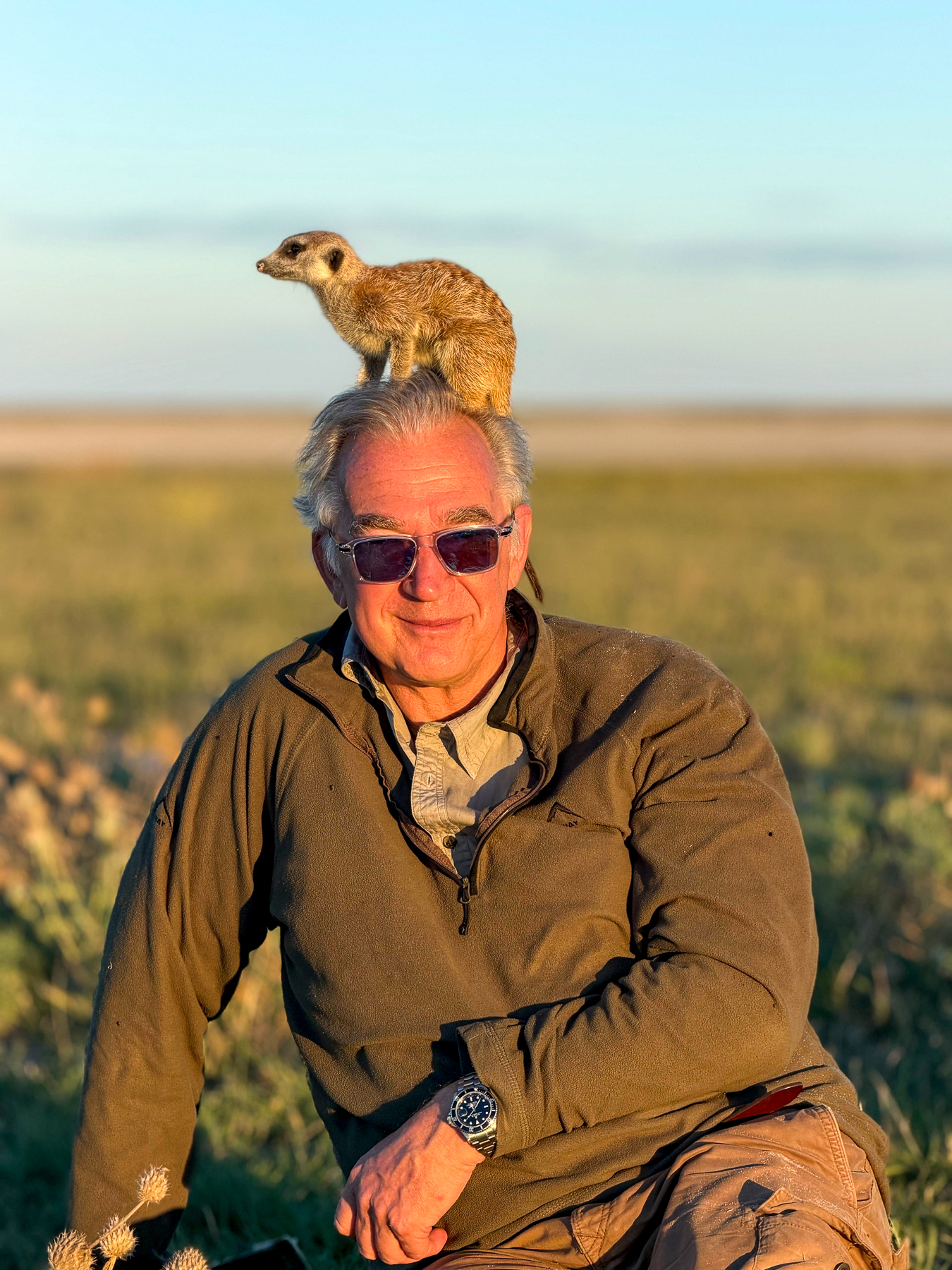 Red Savannah Founder & CEO George Morgan-Grenville with a meerkat on his head in Botswana
