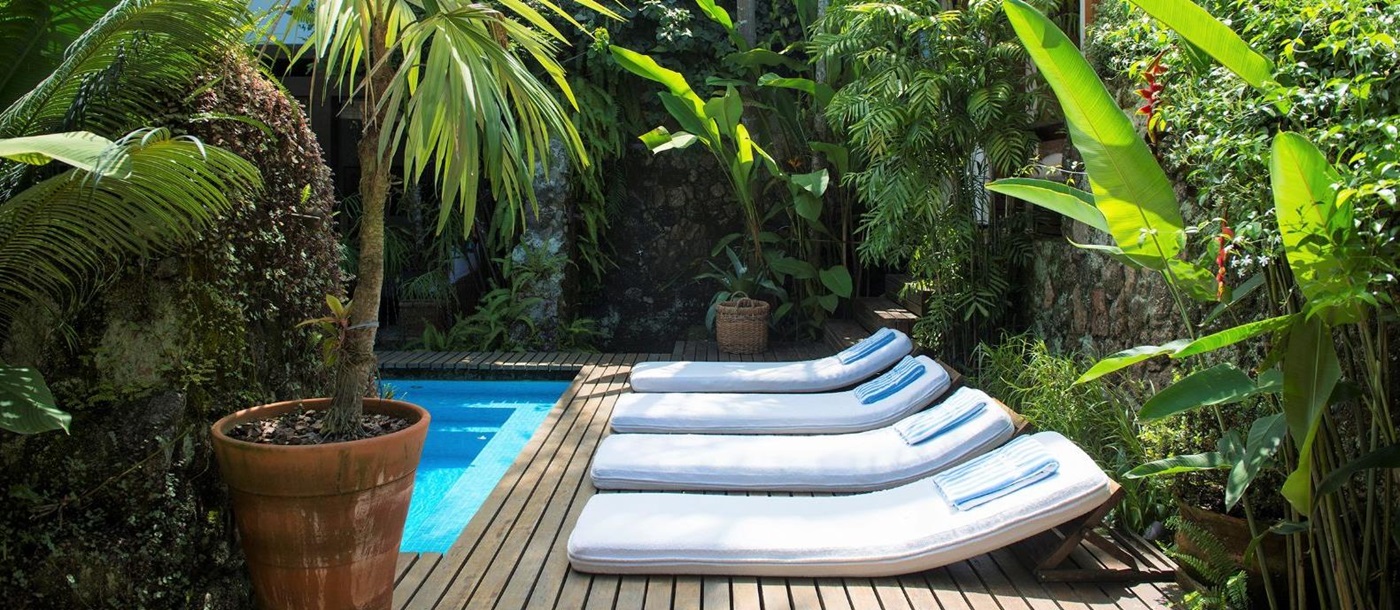 Loungers by the pool at Casa Turquesa in Paraty, Brazil