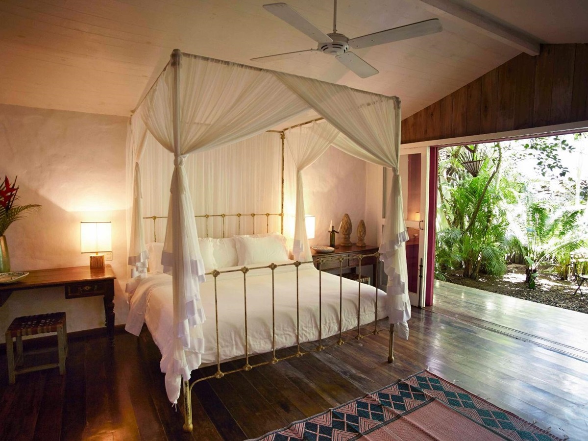 Cosy bedroom with open plan to outdoor pool at luxury resort Uxua Casa Hotel and Spa in Brazil