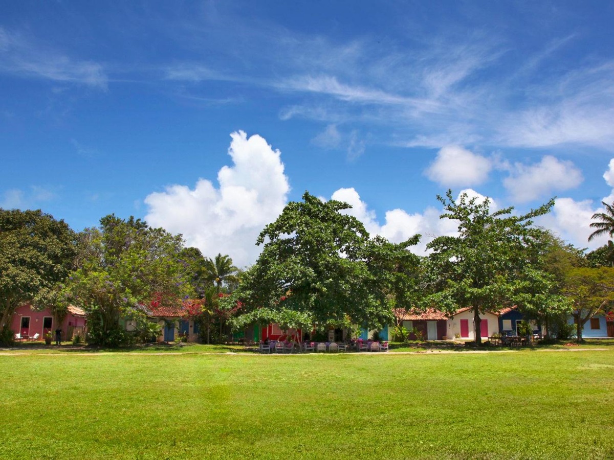 Exterior view of colourful casa accommodation set in thick greenery at luxury resort Uxua Casa Hotel and Spa in Brazil
