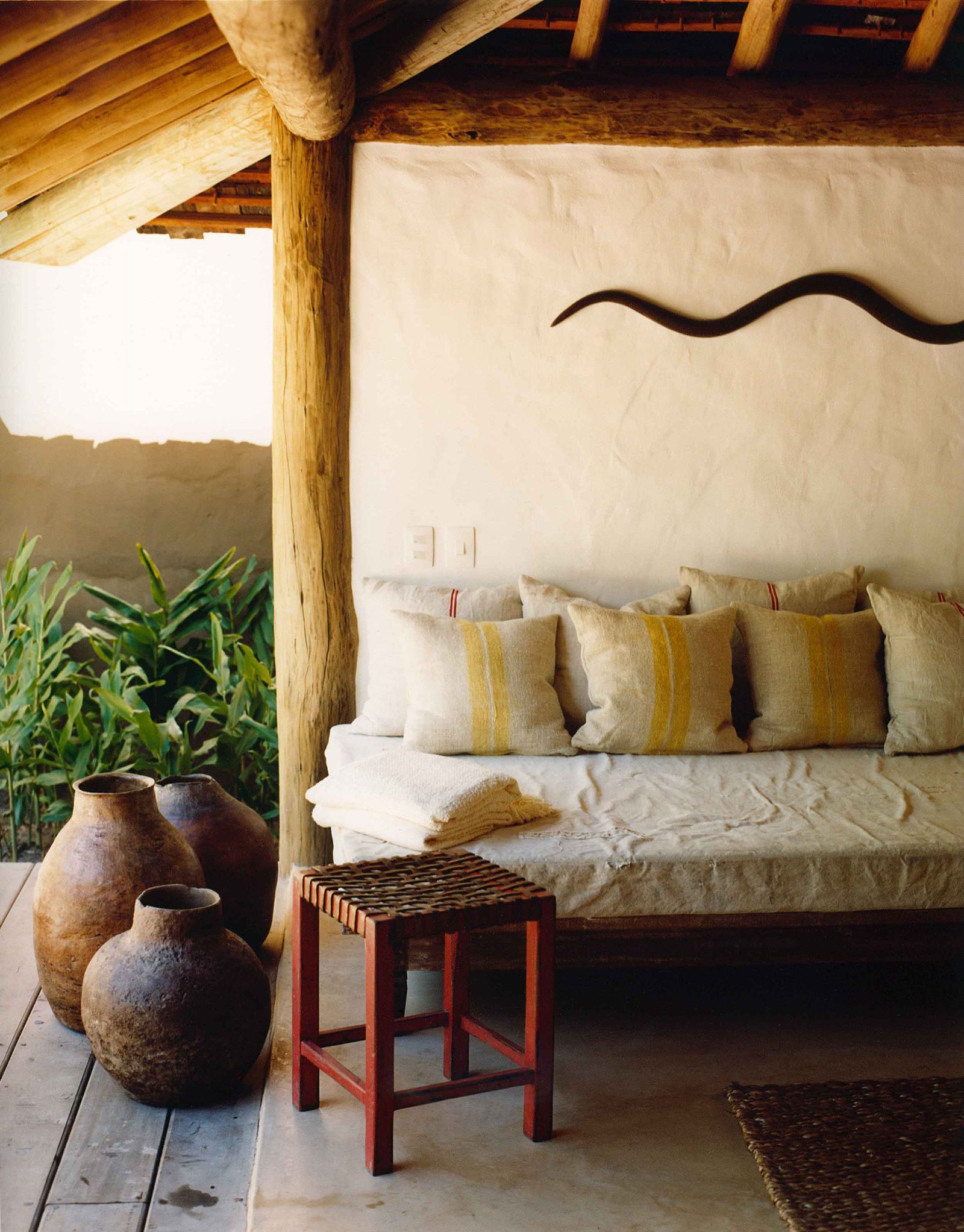 Outdoor lounge pool area with wooden accents at luxury resort Uxua Casa Hotel and Spa in Brazil