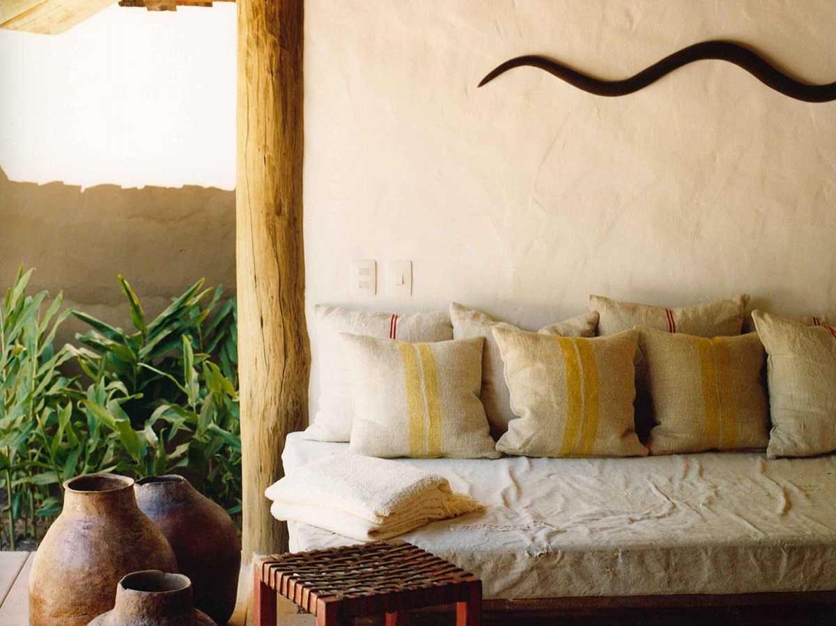 Outdoor lounge pool area with wooden accents at luxury resort Uxua Casa Hotel and Spa in Brazil