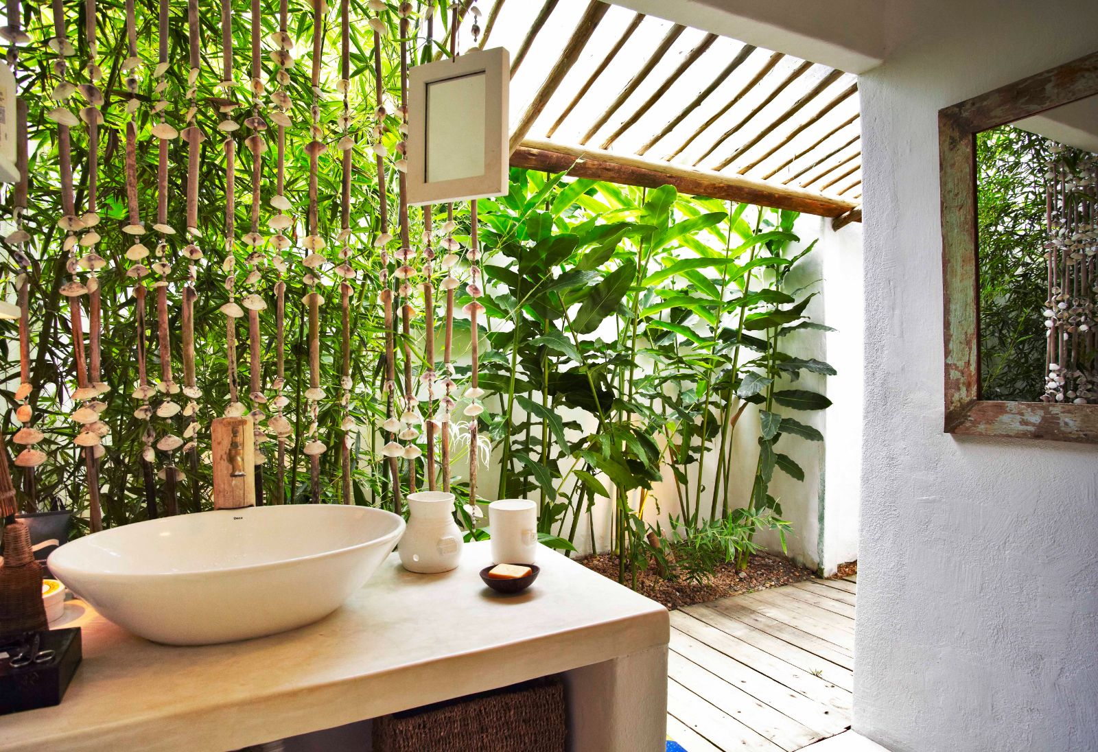 Stand alone sink with walkway leading to outdoor shower in luxury casa suite at luxury resort Uxua Casa Hotel and Spa in Brazil
