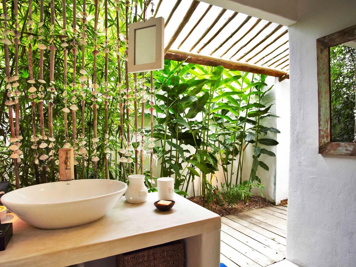 Stand alone sink with walkway leading to outdoor shower in luxury casa suite at luxury resort Uxua Casa Hotel and Spa in Brazil
