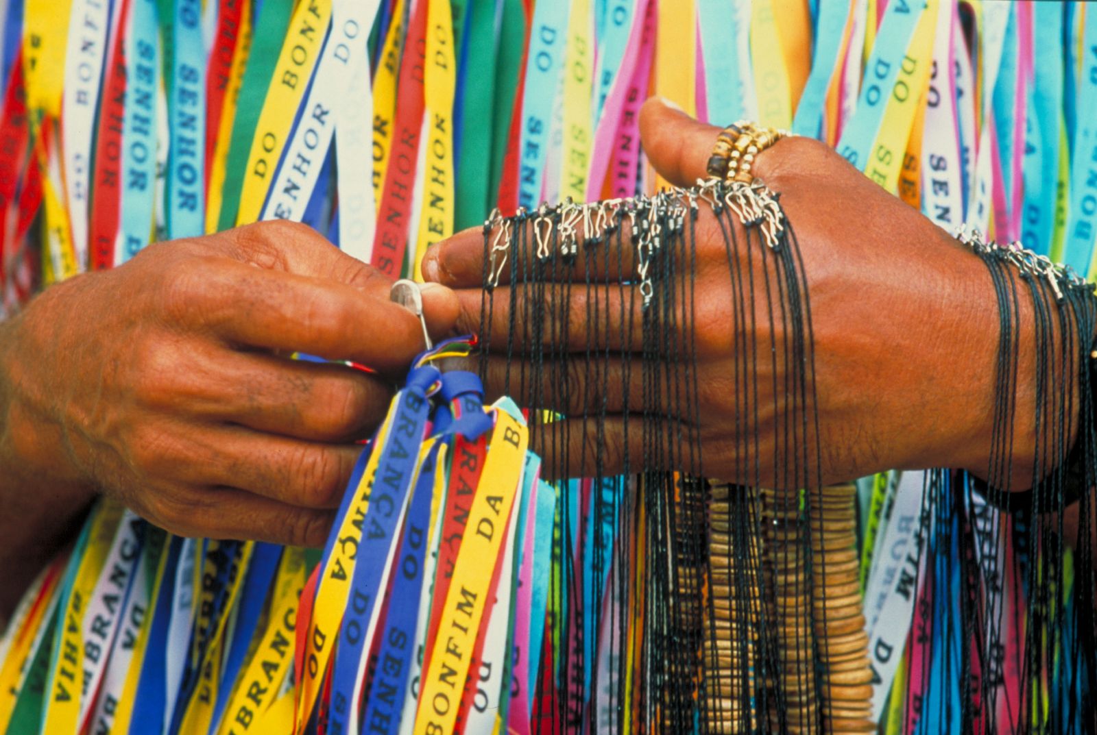 Local man selling Bonfim ribbons in Salvador, Brazil