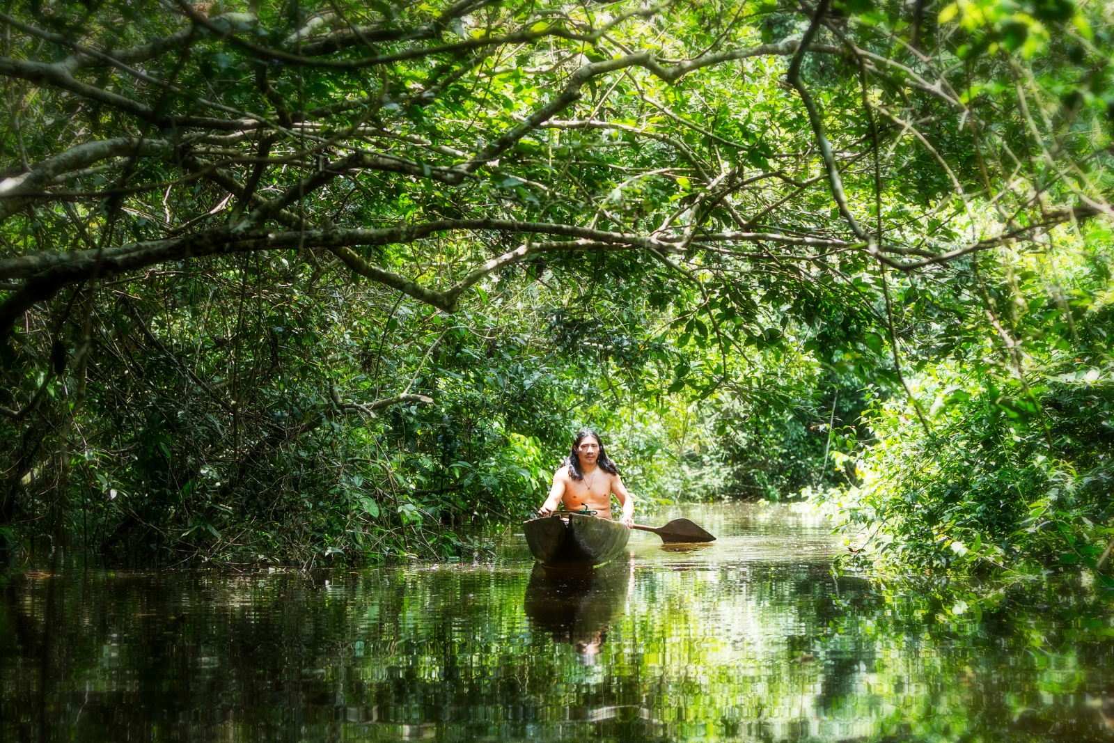 An indigenous old man canoeing, Brazil