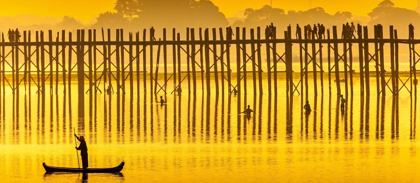 Silhouette of a fisherman and the U-bein bridge at sunset near Mandalay in Burma