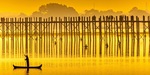 Silhouette of a fisherman and the U-bein bridge at sunset near Mandalay in Burma