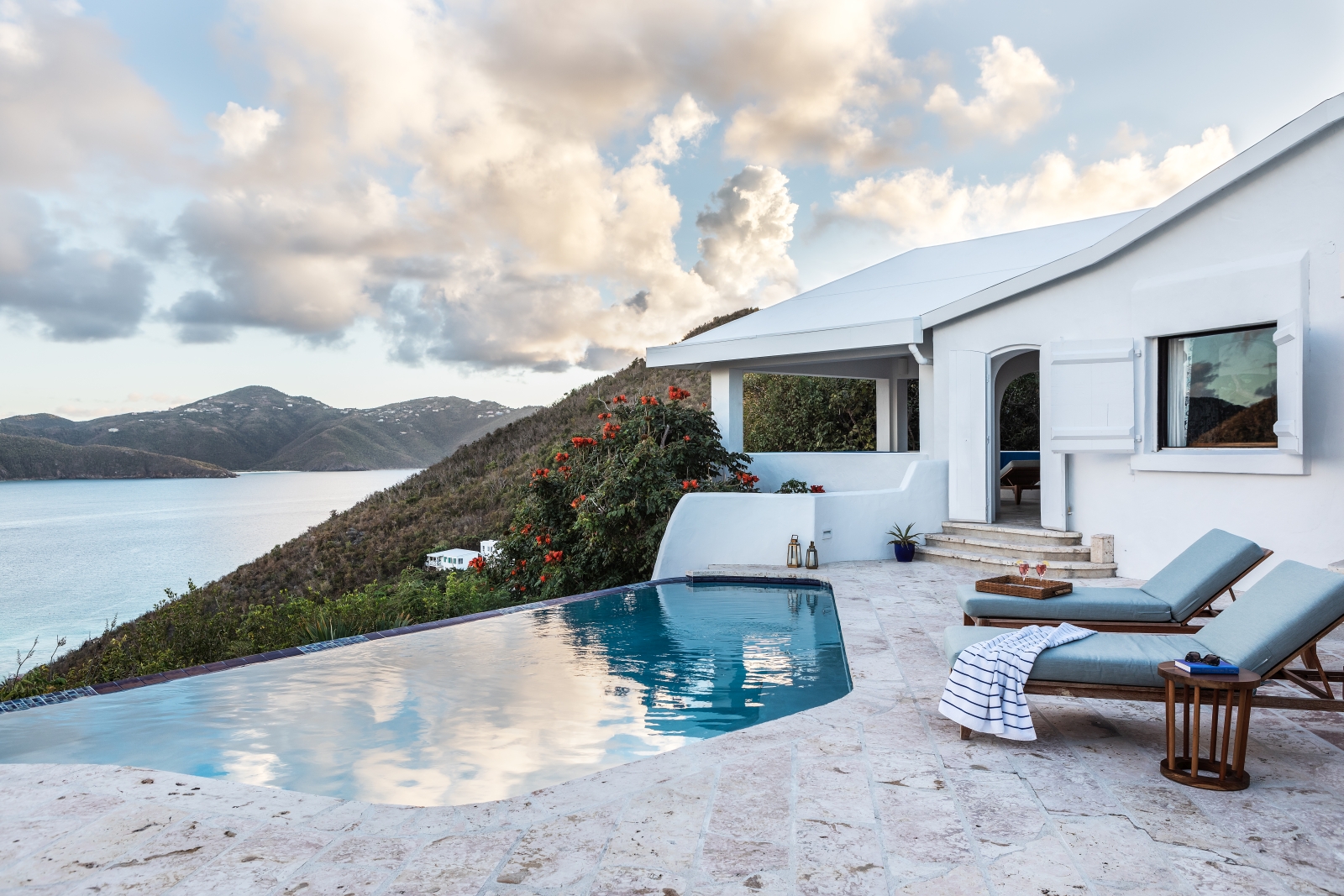 Private balcony with loungers and pool overlooking the sea