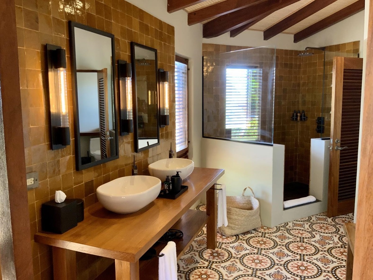 Tiled bathroom with walk in shower and double vanity