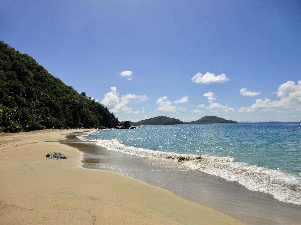 Sandy beach and ocean with islands on the horizon