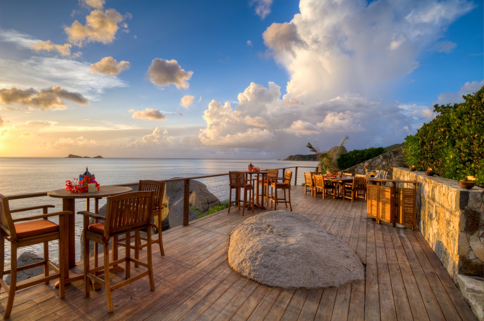 Wooden terrace at sunset with dining tables