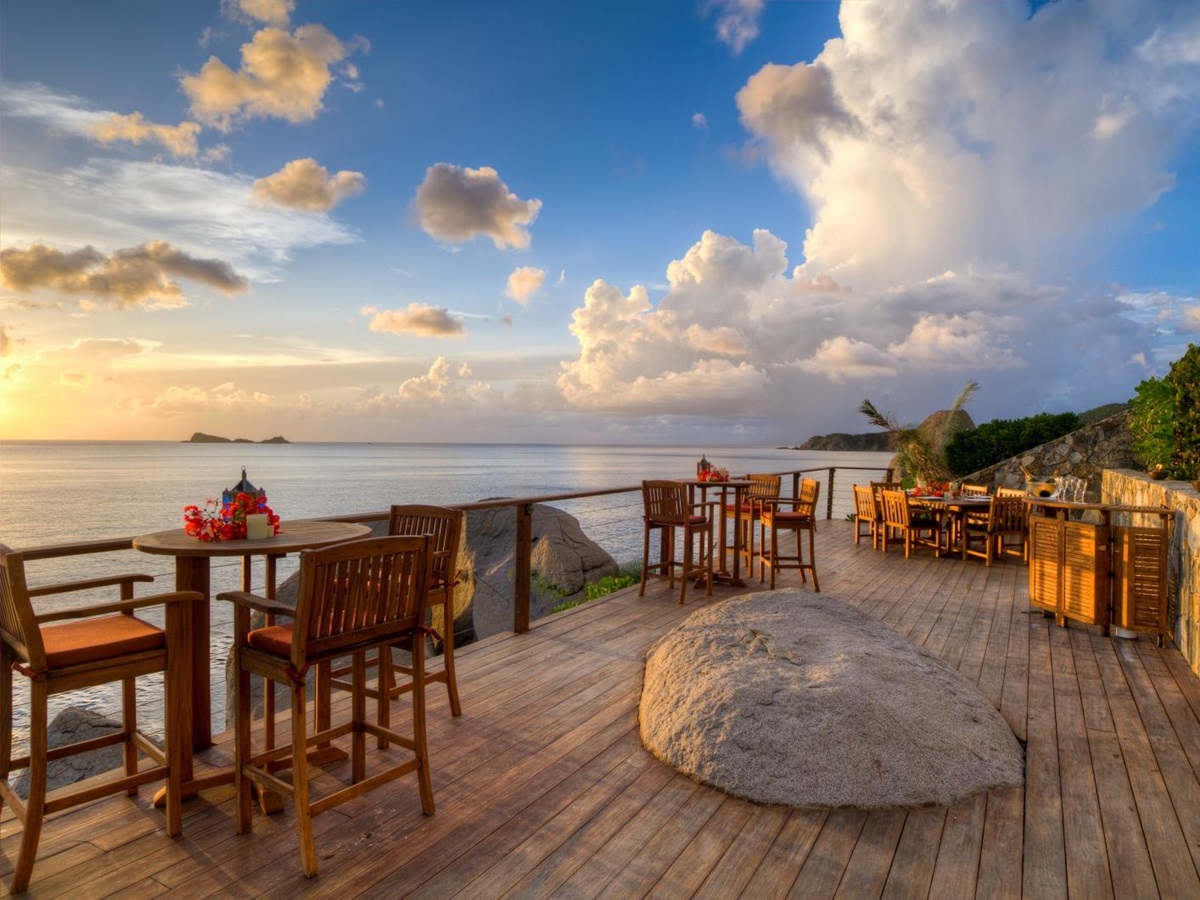 Wooden terrace at sunset with dining tables