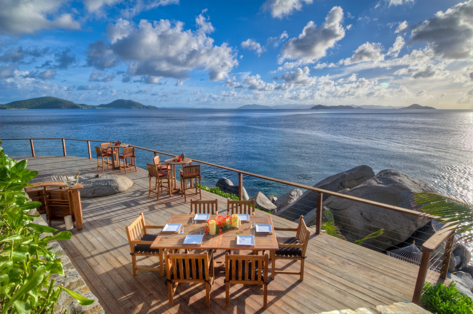 Terrace with dining tables and views across the ocean