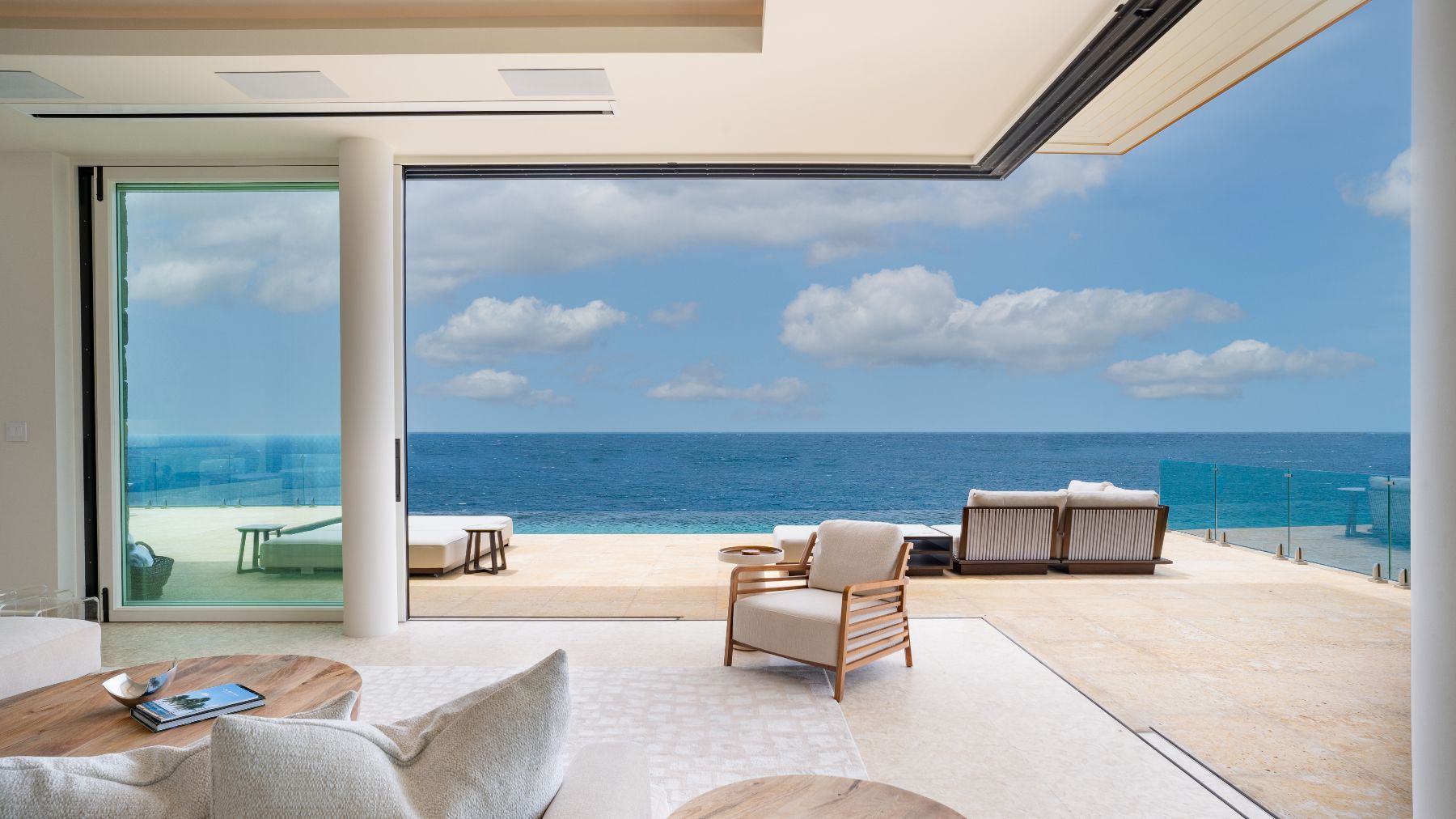 Open plan seating and dining area with sea views at Starlight in the Nut Oil Bay Resort in the British Virgin Islands