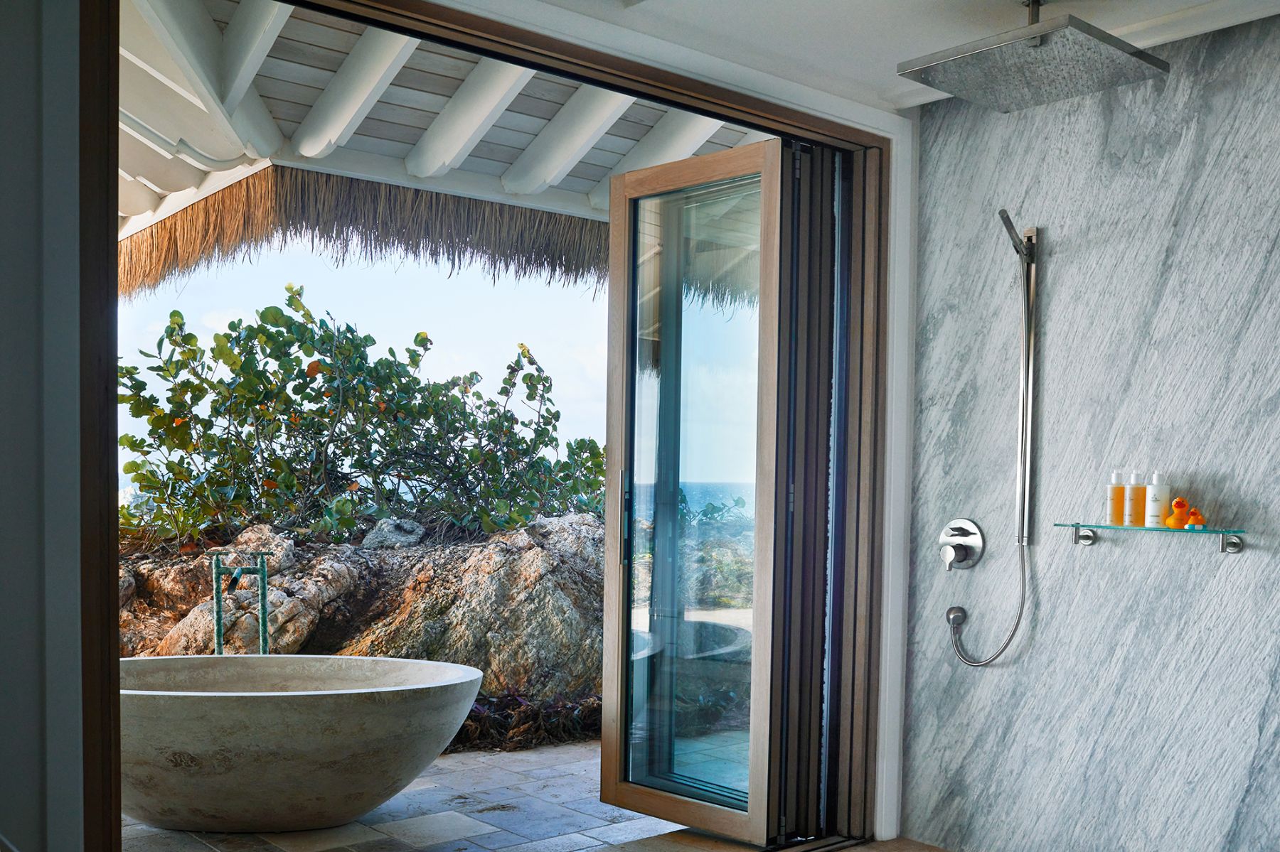 Master bedroom with bath outside at The Branson Estate on Moskito Island in the British Virgin Islands