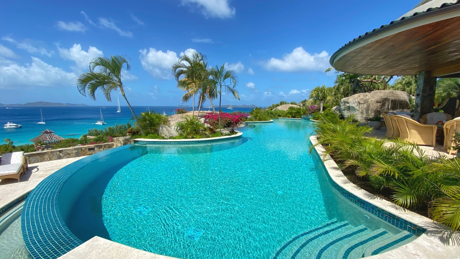 Large pool with sea view next to patio area at Valley Trunk on the British Virgin Islands, Caribbean