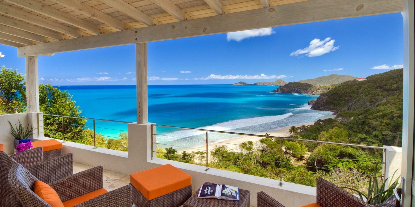 outdoor sitting area with view over beach at swimming pool of Villa Soleile, British Virgin Islands