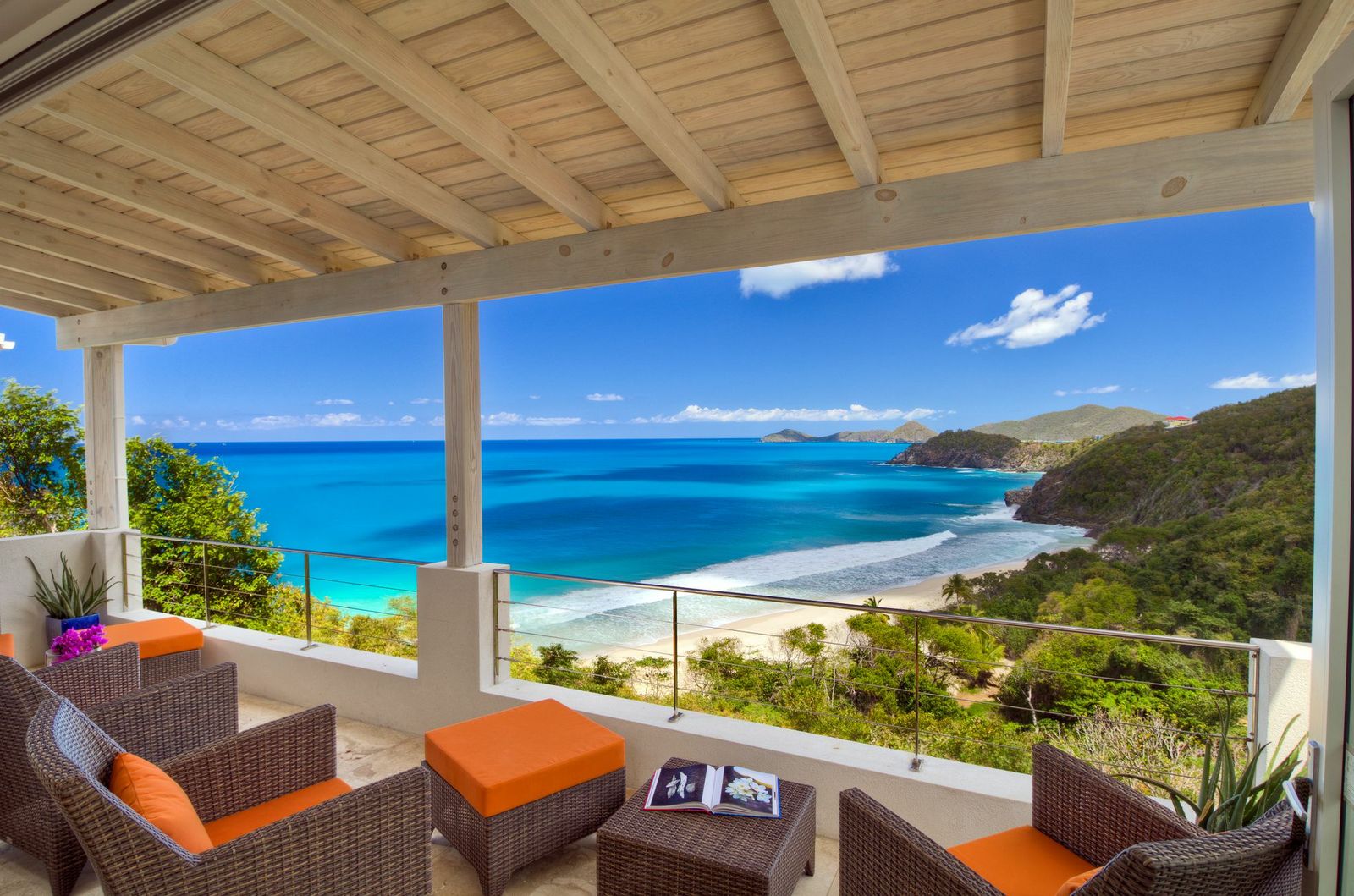 outdoor sitting area with view over beach at swimming pool of Villa Soleile, British Virgin Islands