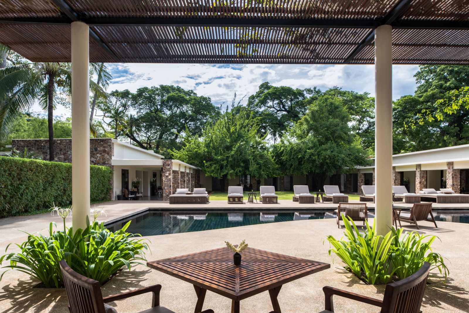 Seating beneath the poolside pergola at Amansara in the Siem Reap region of Cambodia