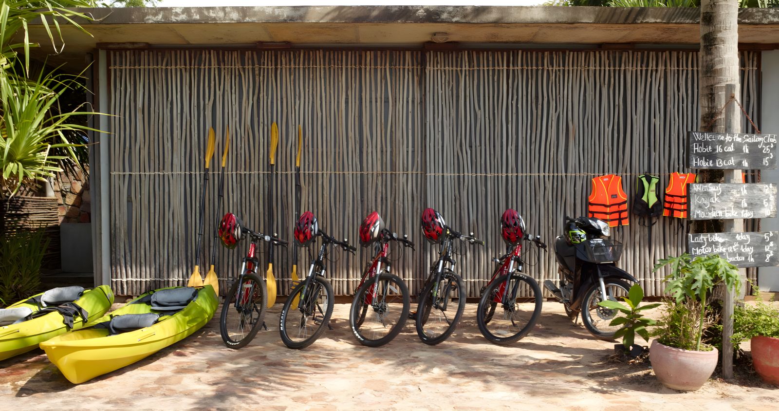 Beach club exterior with bicycles and water sports gear to rent at Knai Bang Chatt resort in Cambodia