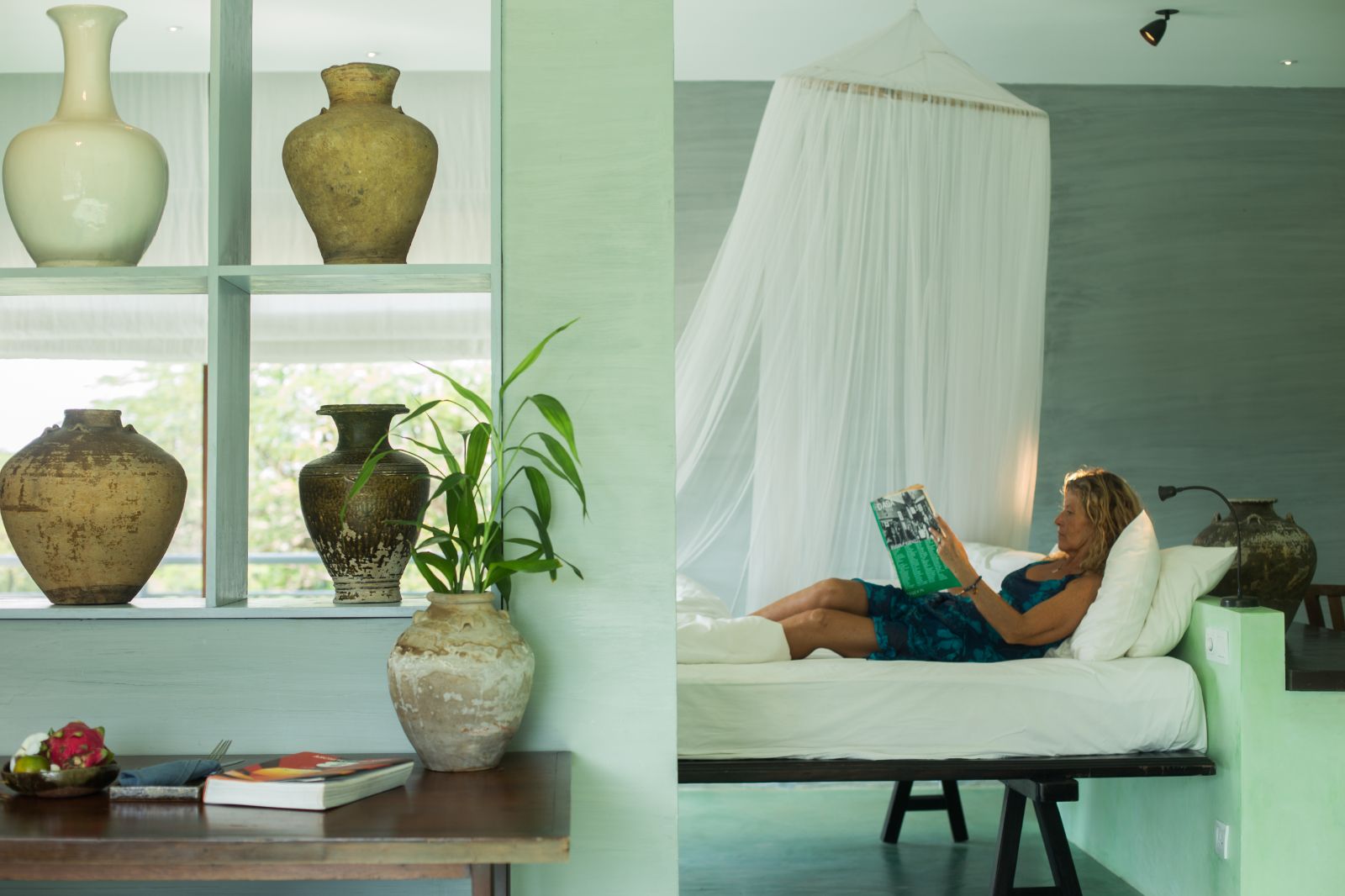 Green guest suite with ceramics at Knai Bang Chatt resort in Cambodia