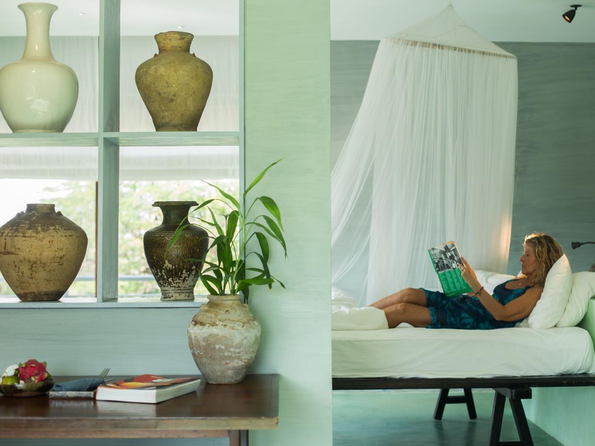 Green guest suite with ceramics at Knai Bang Chatt resort in Cambodia
