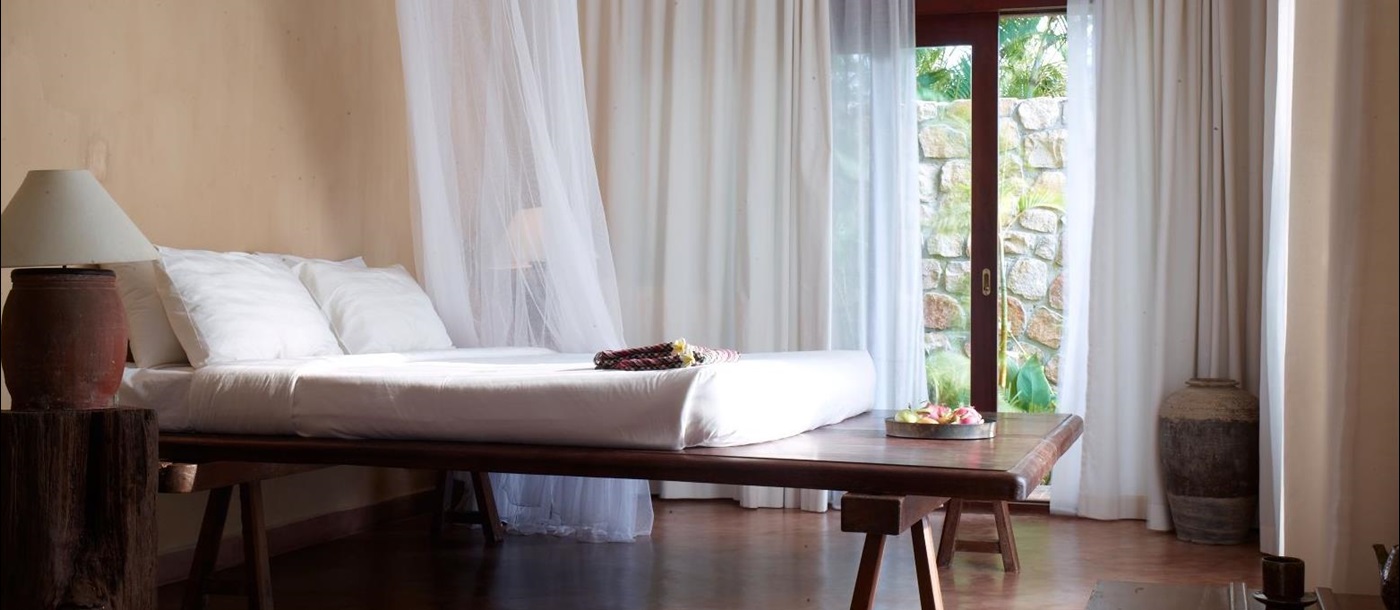 Guest suite bedroom at Knai Bang Chatt resort in Cambodia