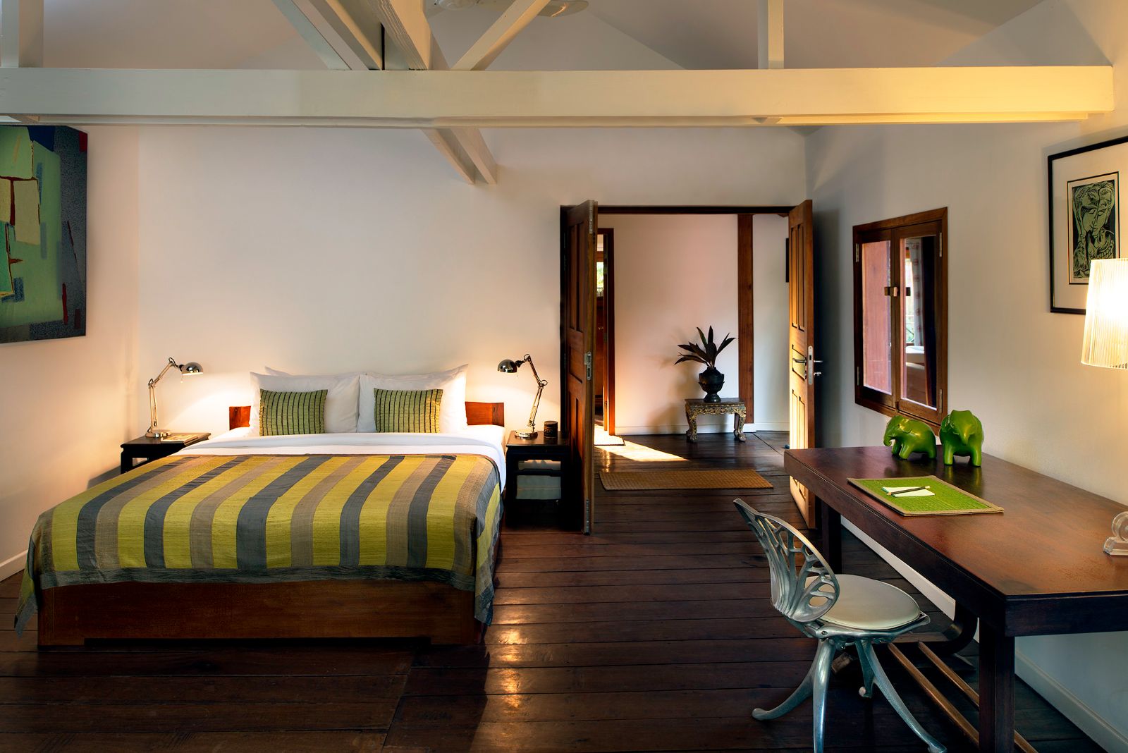 Green guest suite bedroom at Maison Polanka in Cambodia's Siem Reap