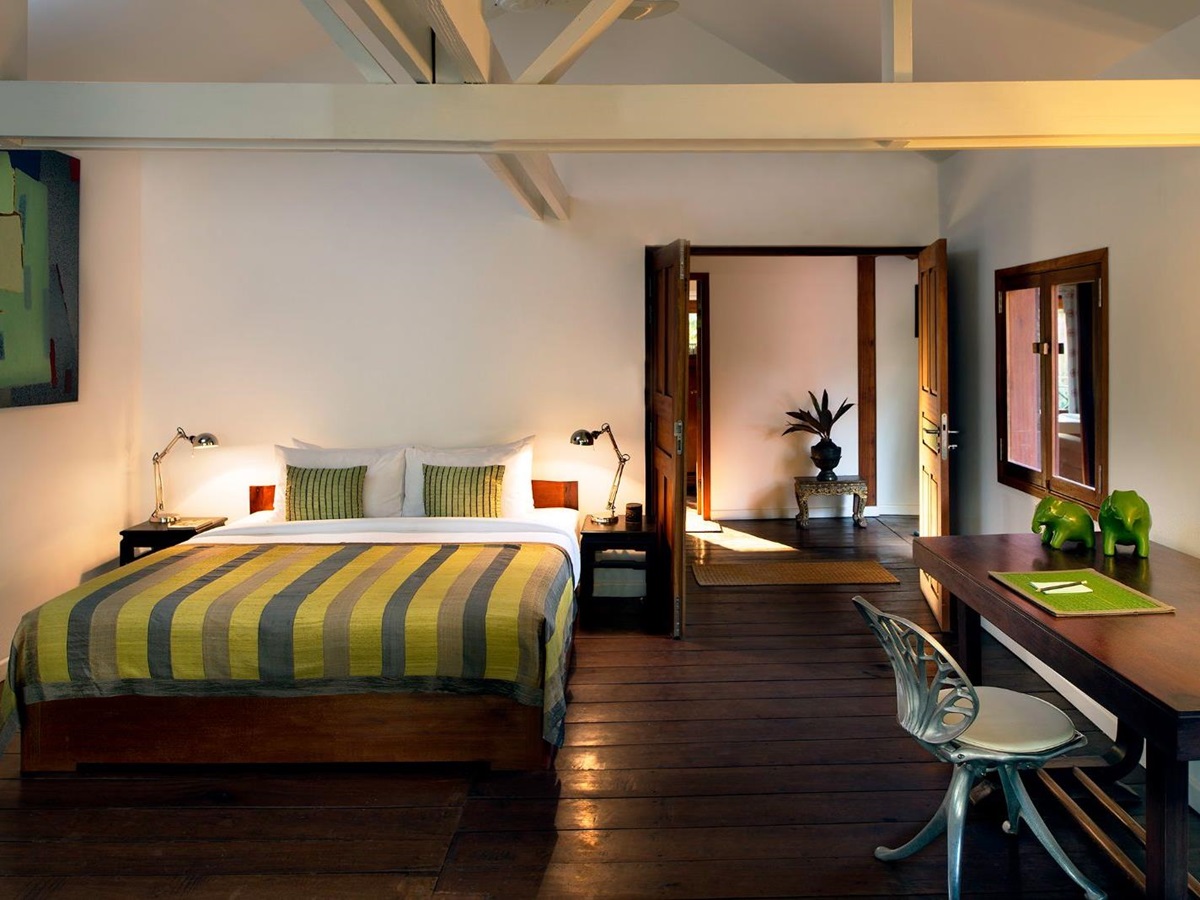 Green guest suite bedroom at Maison Polanka in Cambodia's Siem Reap