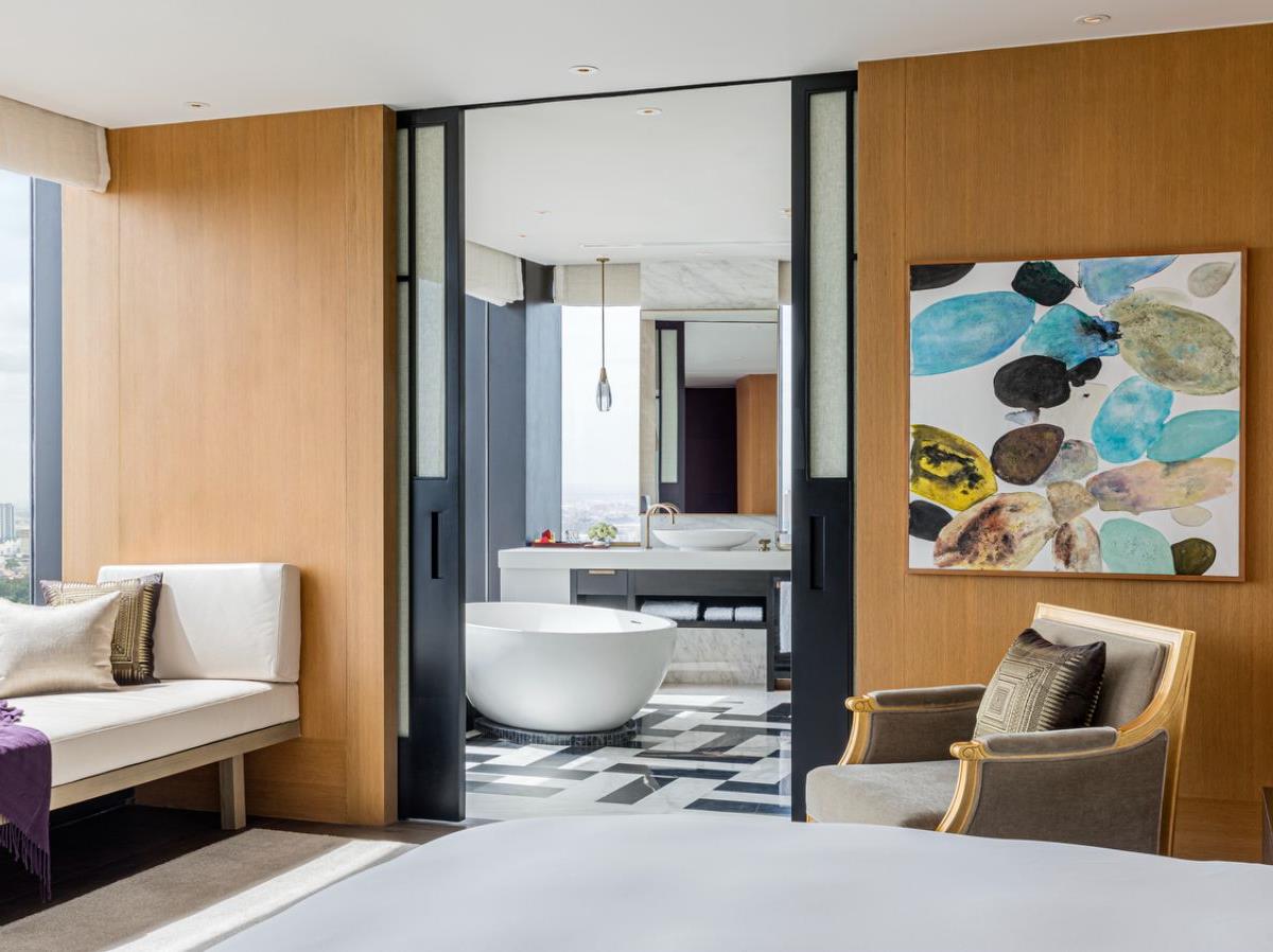 Norodom guest suite bedroom and living area at Rosewood Phnom Penh in Cambodia