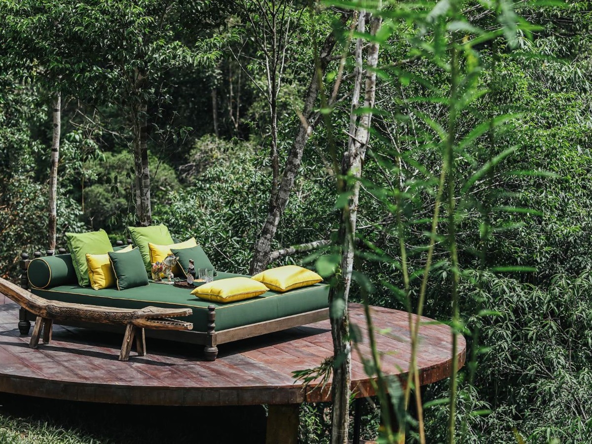 Daybed on platform surrounded by trees at Luxury resort Shinta Mani Wild