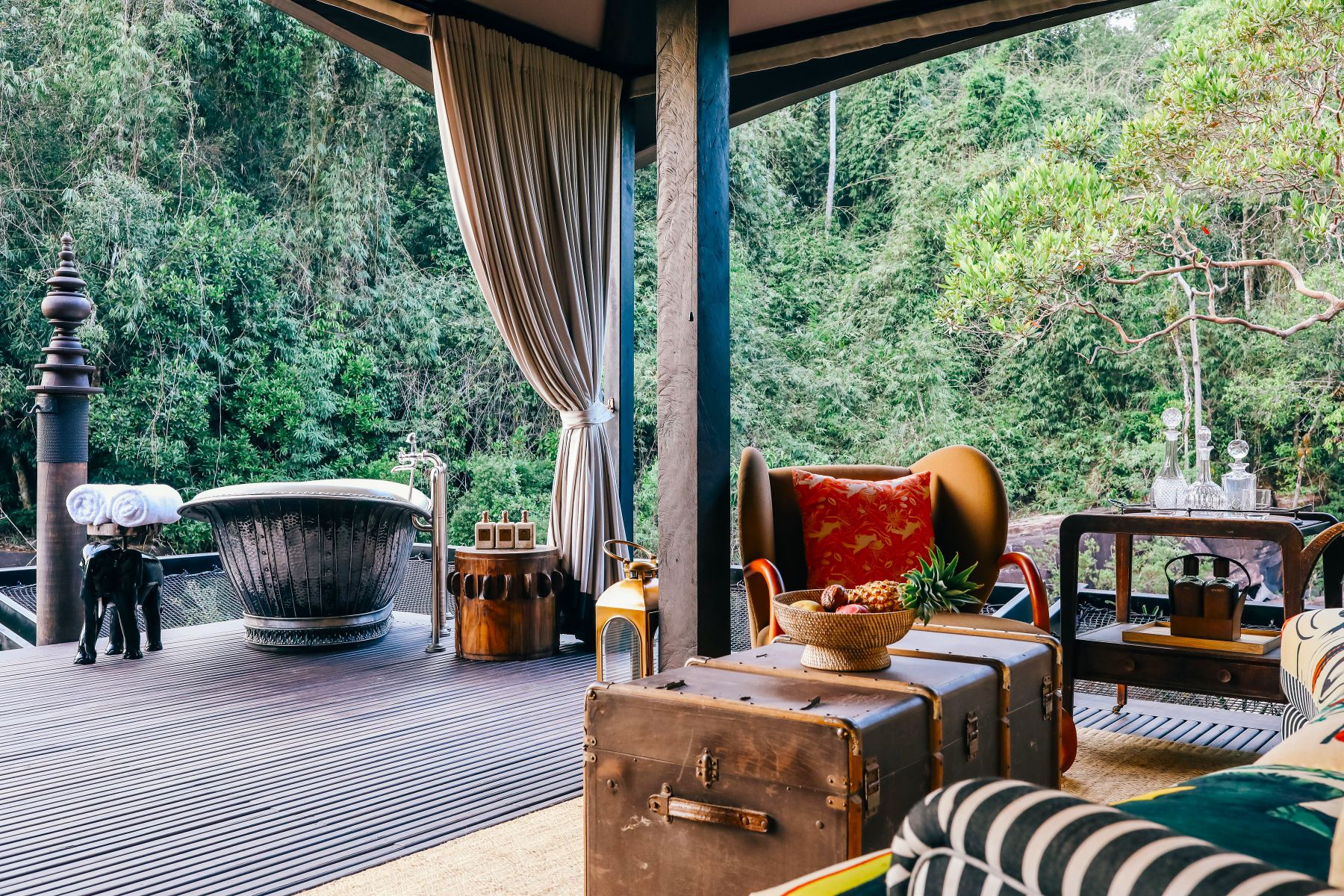 Private terrace with outdoor lounge and bathtub at Shinta Mani Wild Cambodia