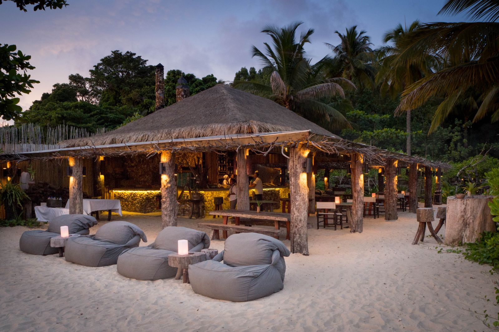 Beanbags on beach during sunset at luxury resort Song Saa