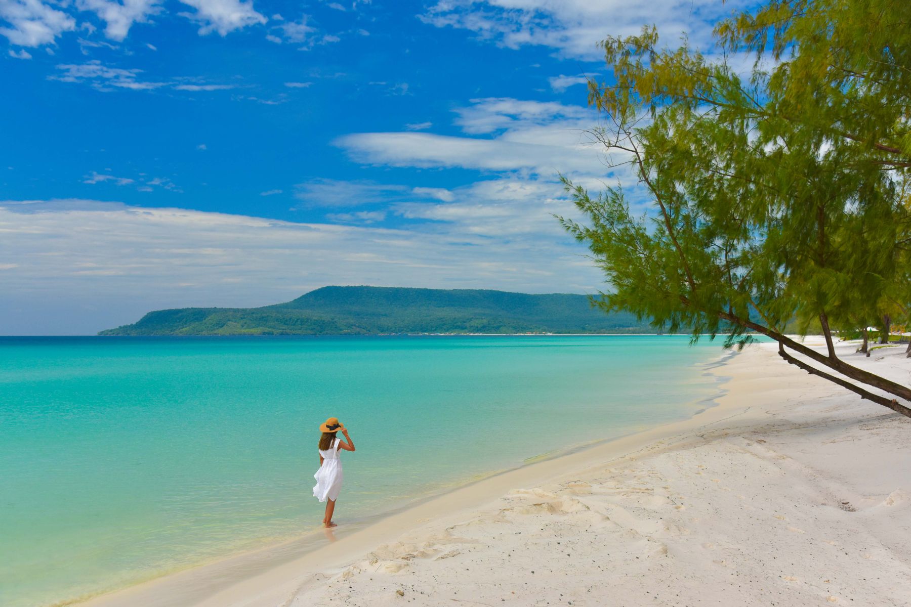 Lady in white dress walking along the beach at Royal Sands Koh Rong Cambodia