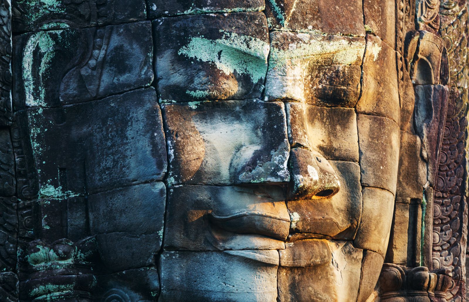 Close up of enormous stone buddha face at the Bayon Temple in Angkor Cambodia