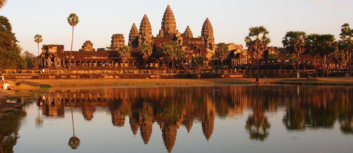 Angkor Wat temple during sunrise reflecting onto the lake below