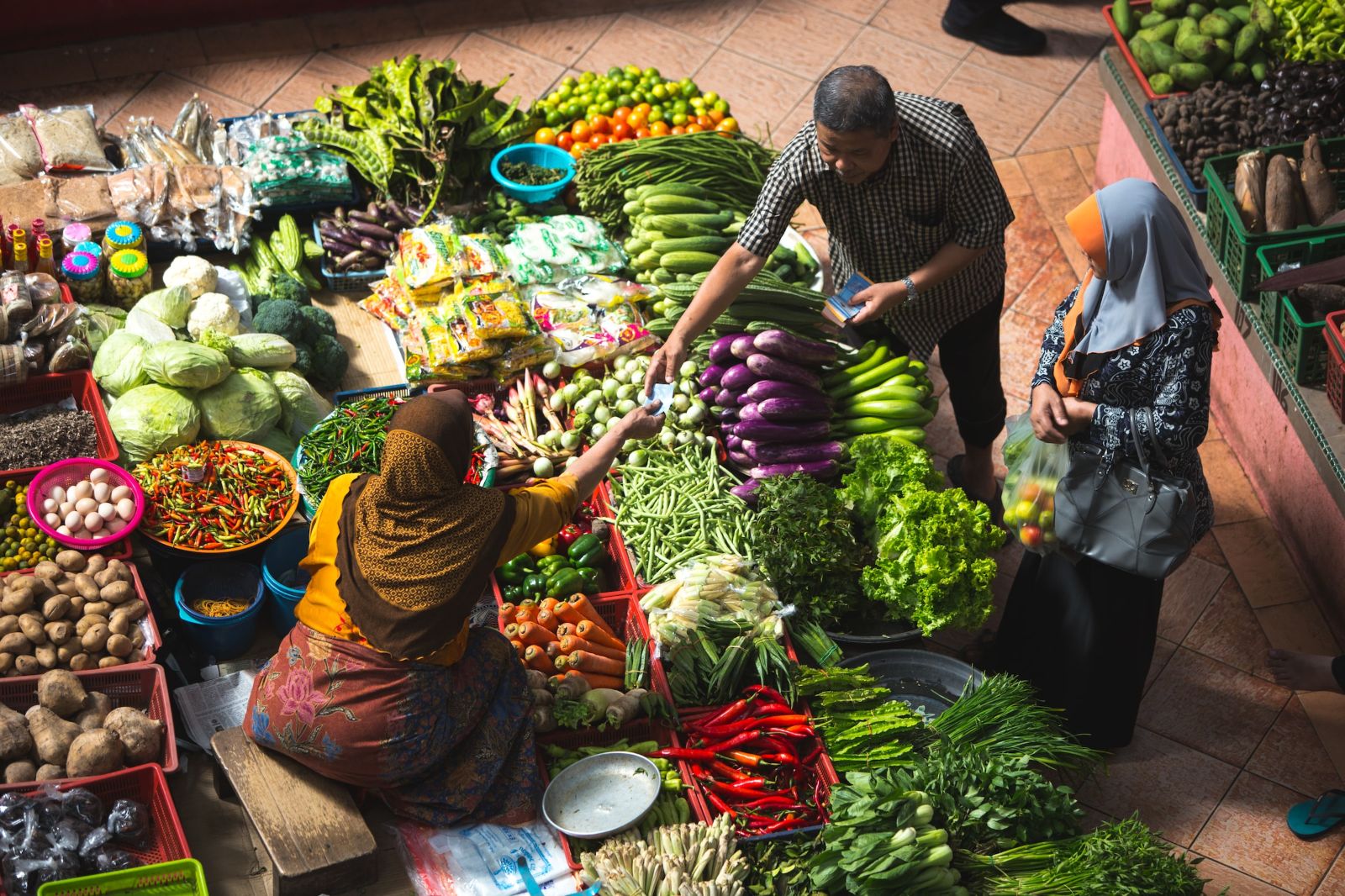 A woman selling food at a Cambodian food market