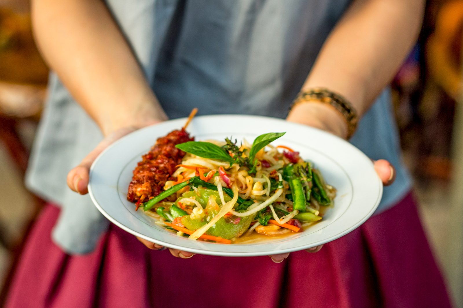 A woman presenting a Khmer dish in Cambodia