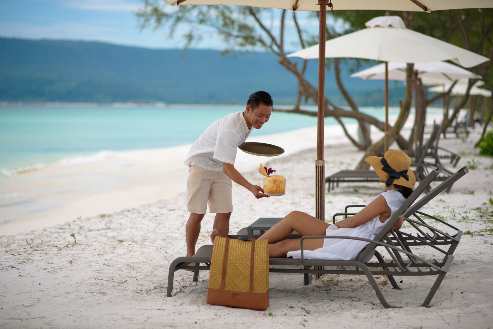 Sun loungers on the beach of The Royal Sands beach resort on Koh Rong in Cambodia