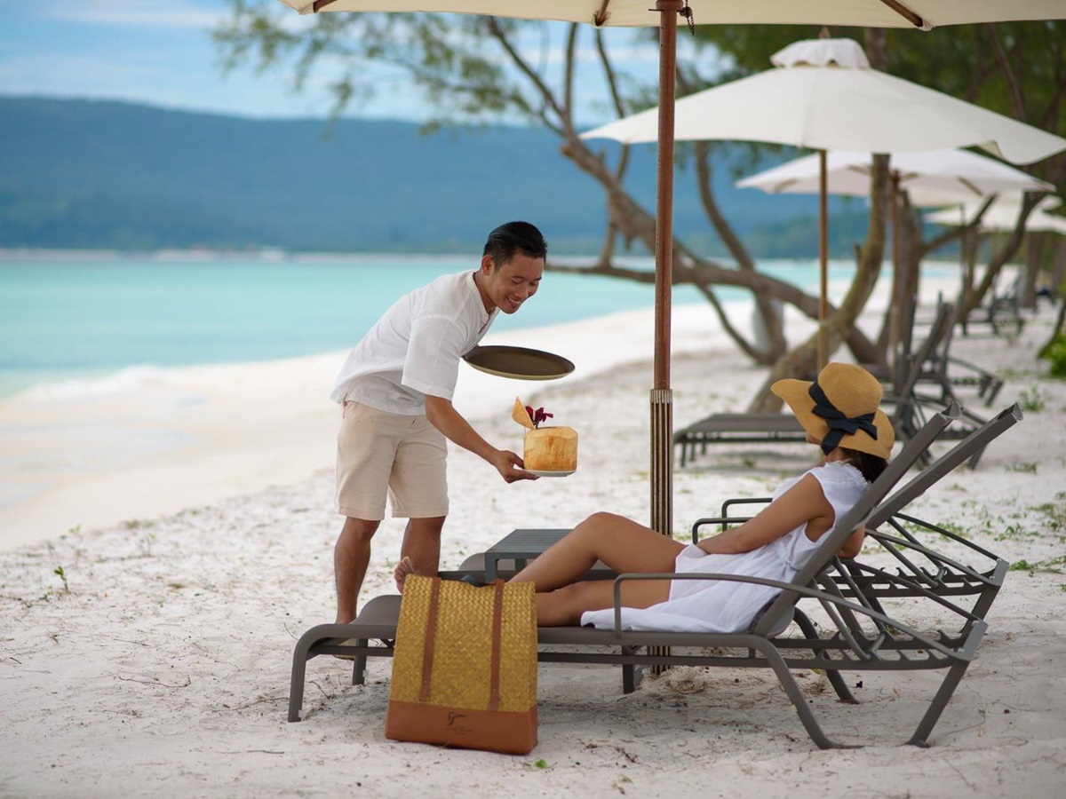 Sun loungers on the beach of The Royal Sands beach resort on Koh Rong in Cambodia