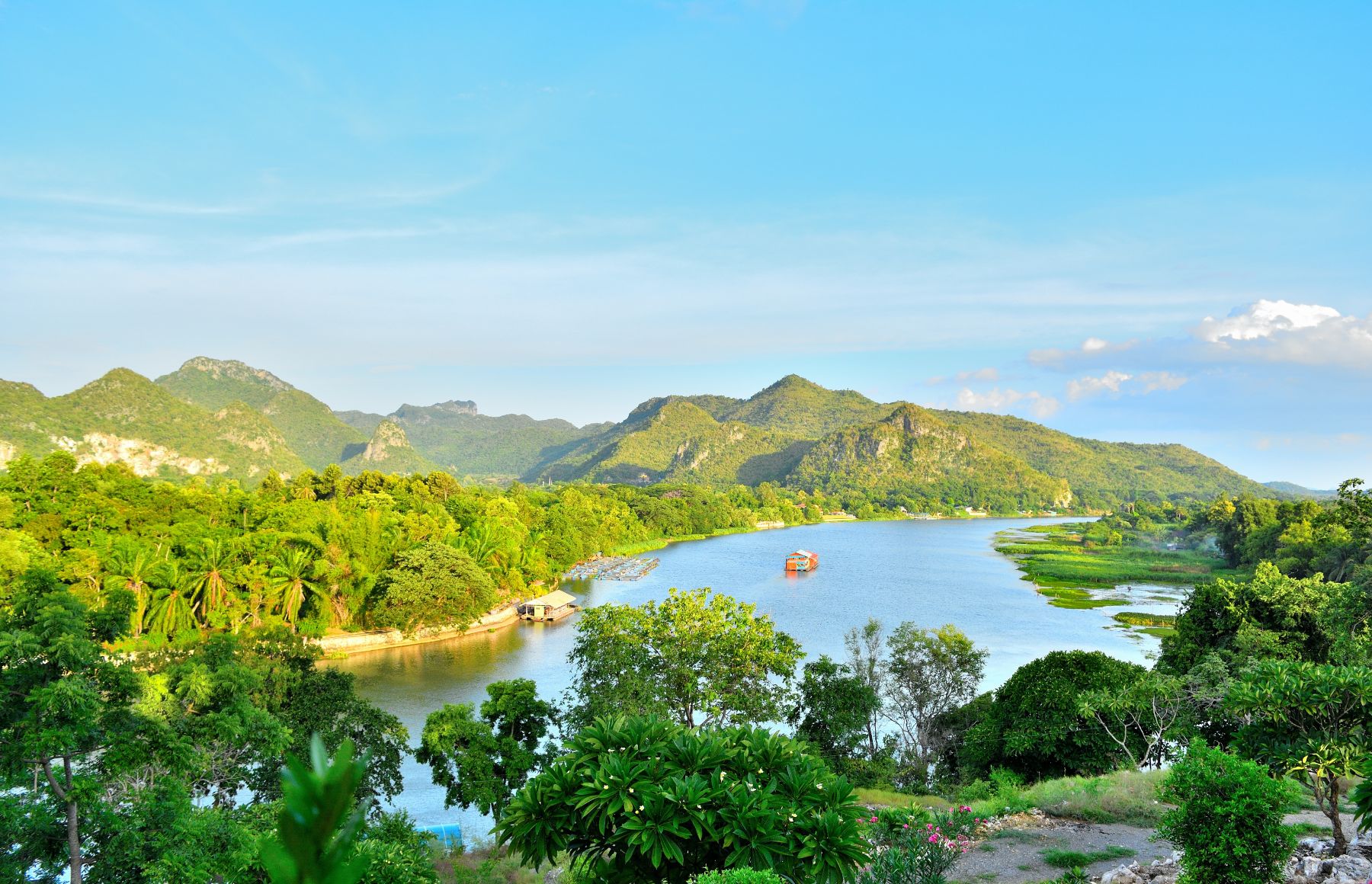 Distant view of a boat on the Mekong River and mountains beyond