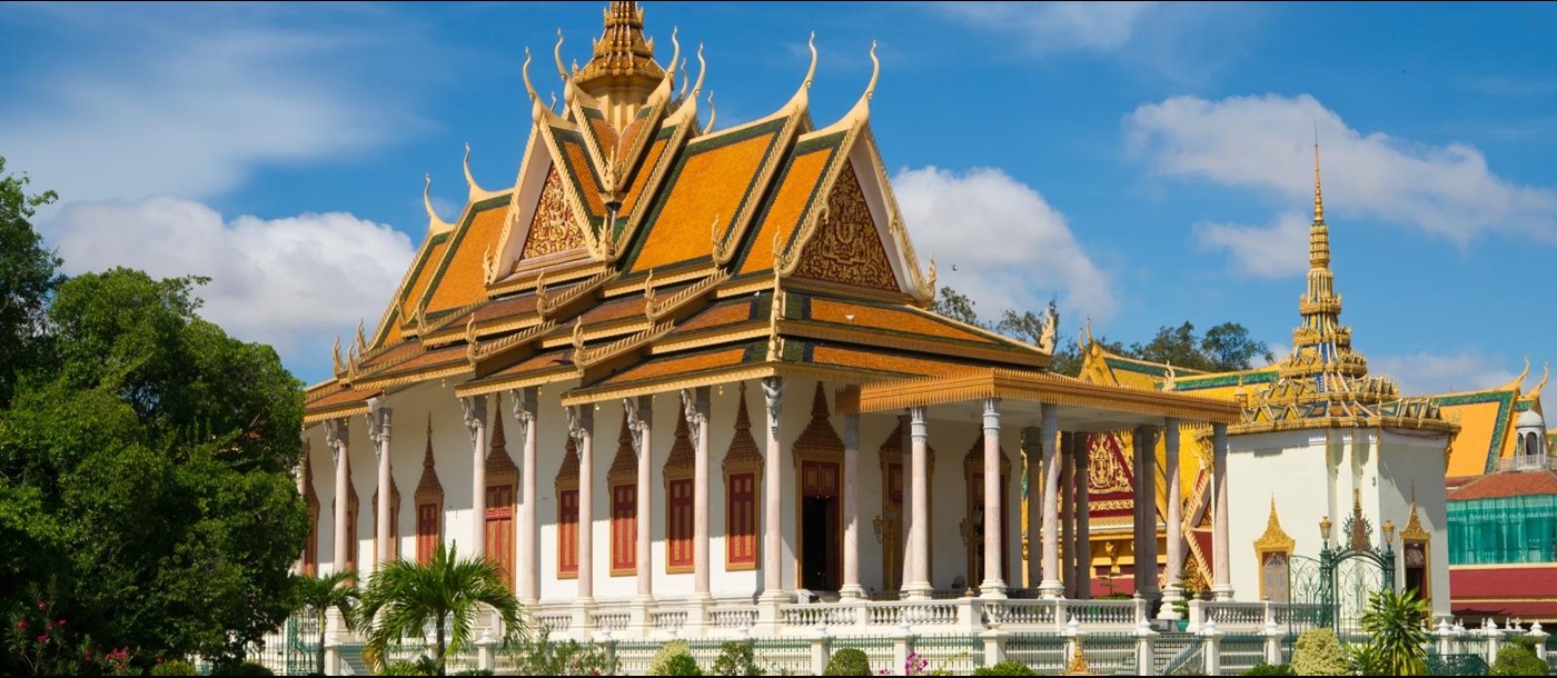 Large gold roofed temple with white columns