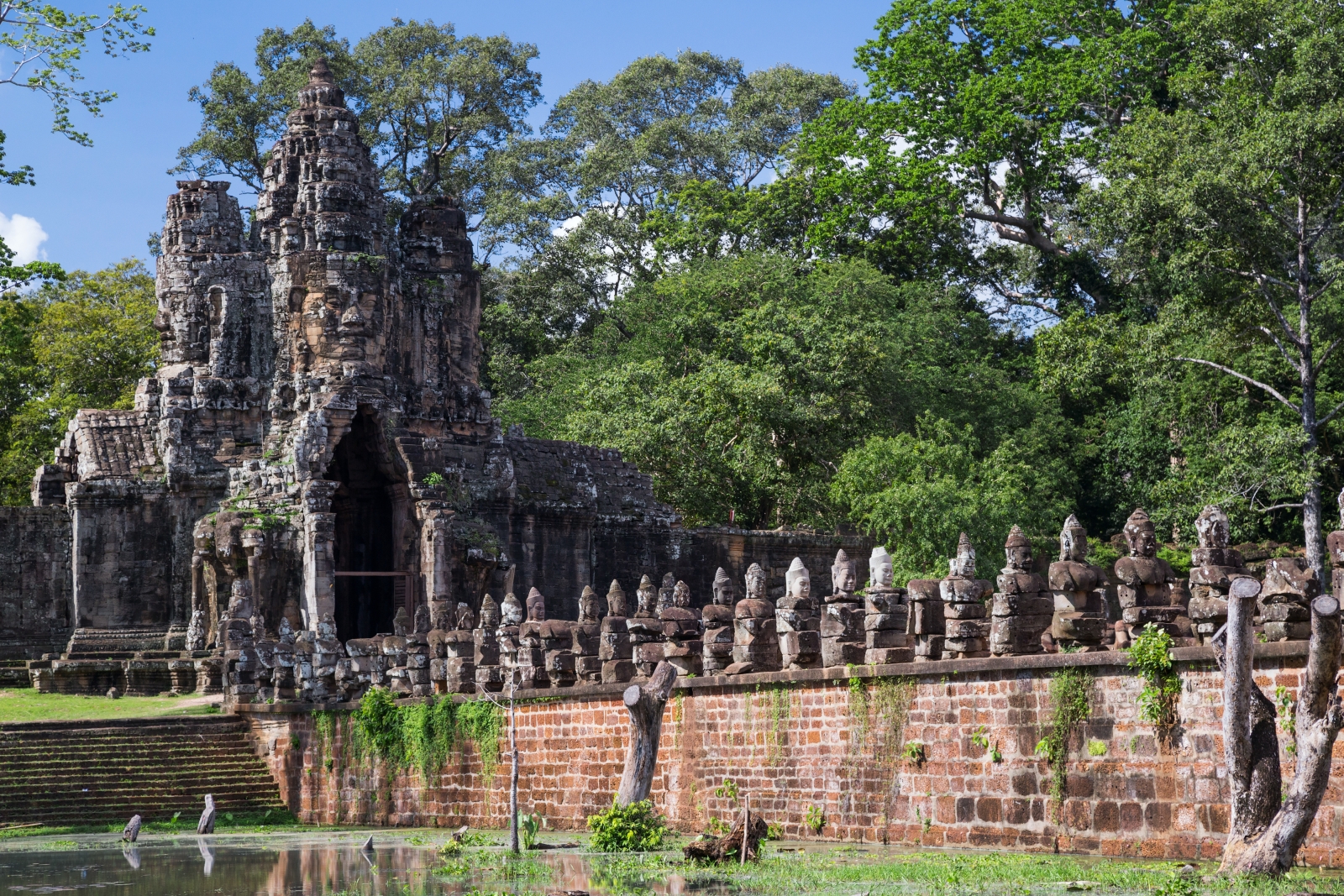 Stone bridge leads towards large ornate archways