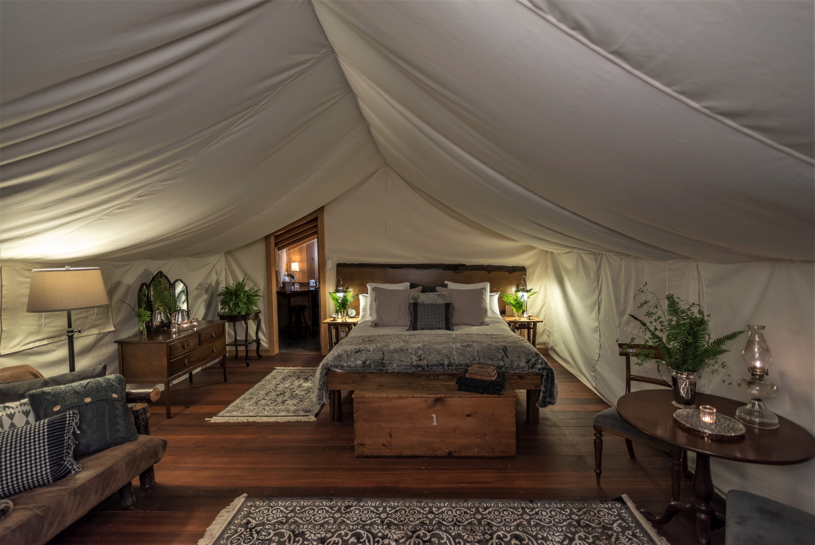 Interior of tent with double bed and sitting area, photo credit to Christopher Morris
