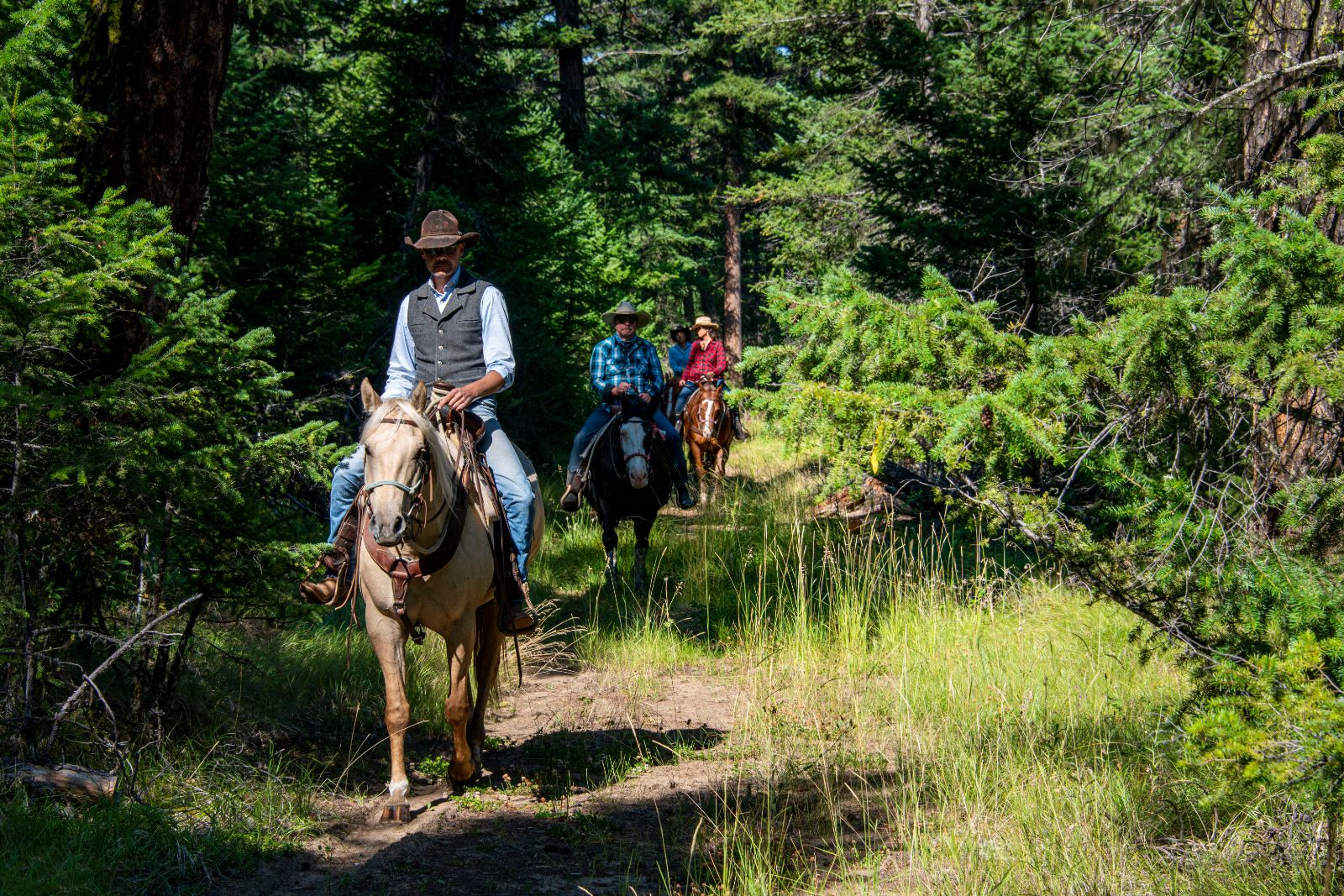Horseback riding through the forest at luxury ranch Echo Valley 
