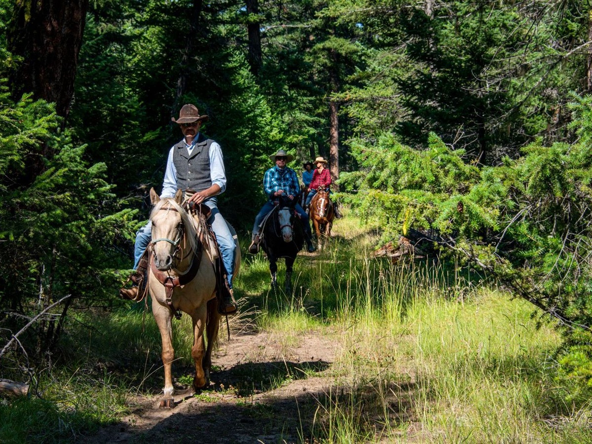 Horseback riding through the forest at luxury ranch Echo Valley