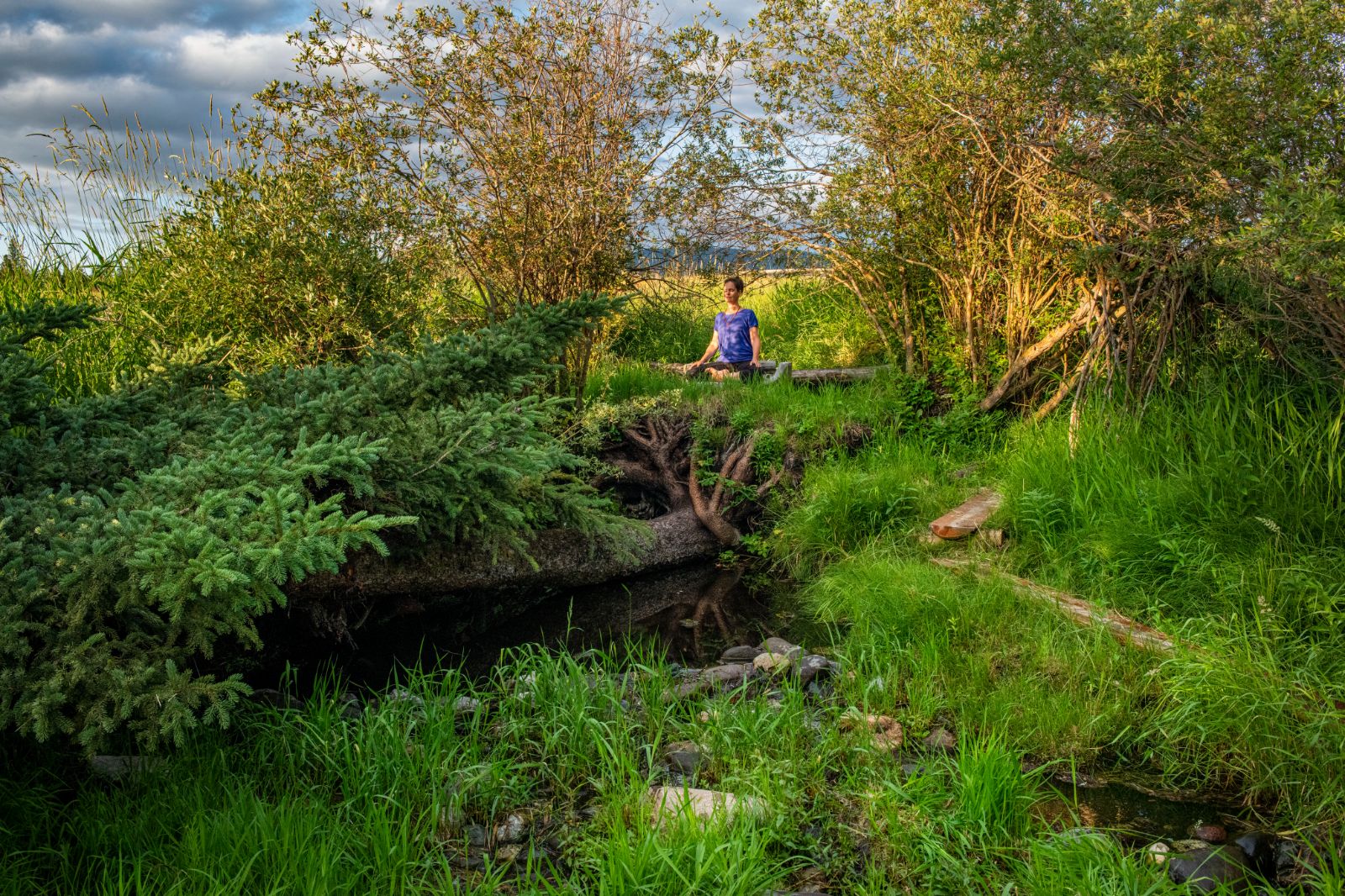 A women meditating in the wilderness at luxury ranch Echo Valley 