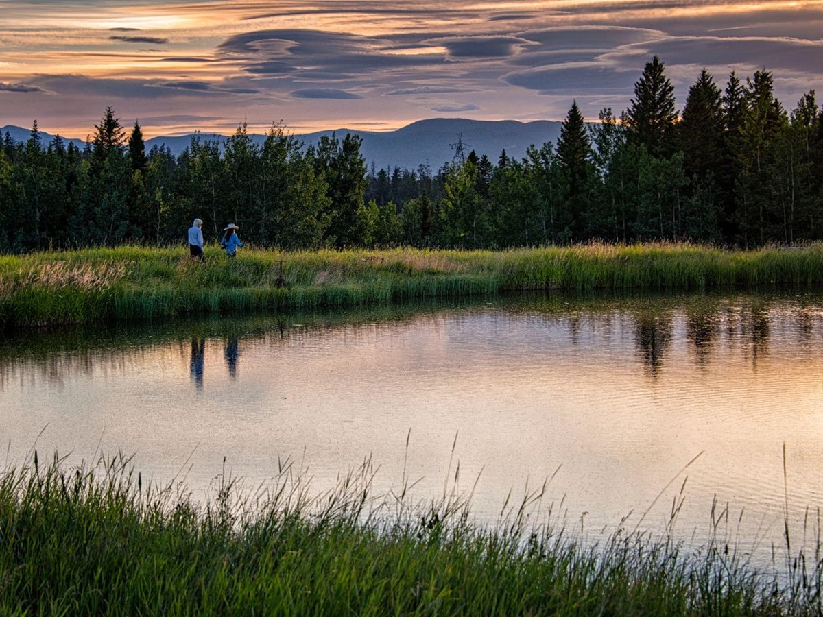 Evening walk around the lake at luxury ranch Echo Valley
