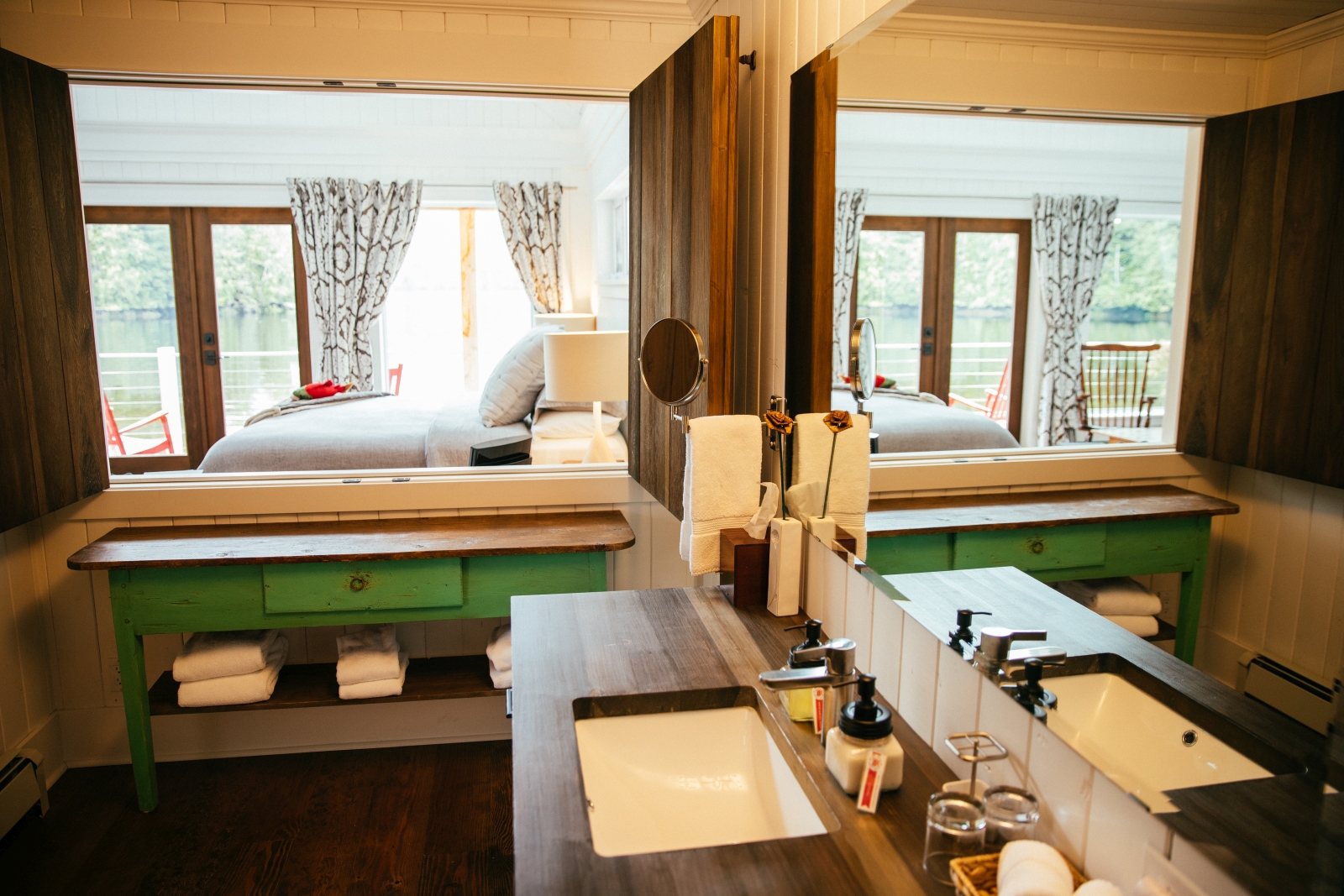 View from the ensuite bathroom of a cabin through a hatch into the room at luxury hotel Nimmo Bay in Canada